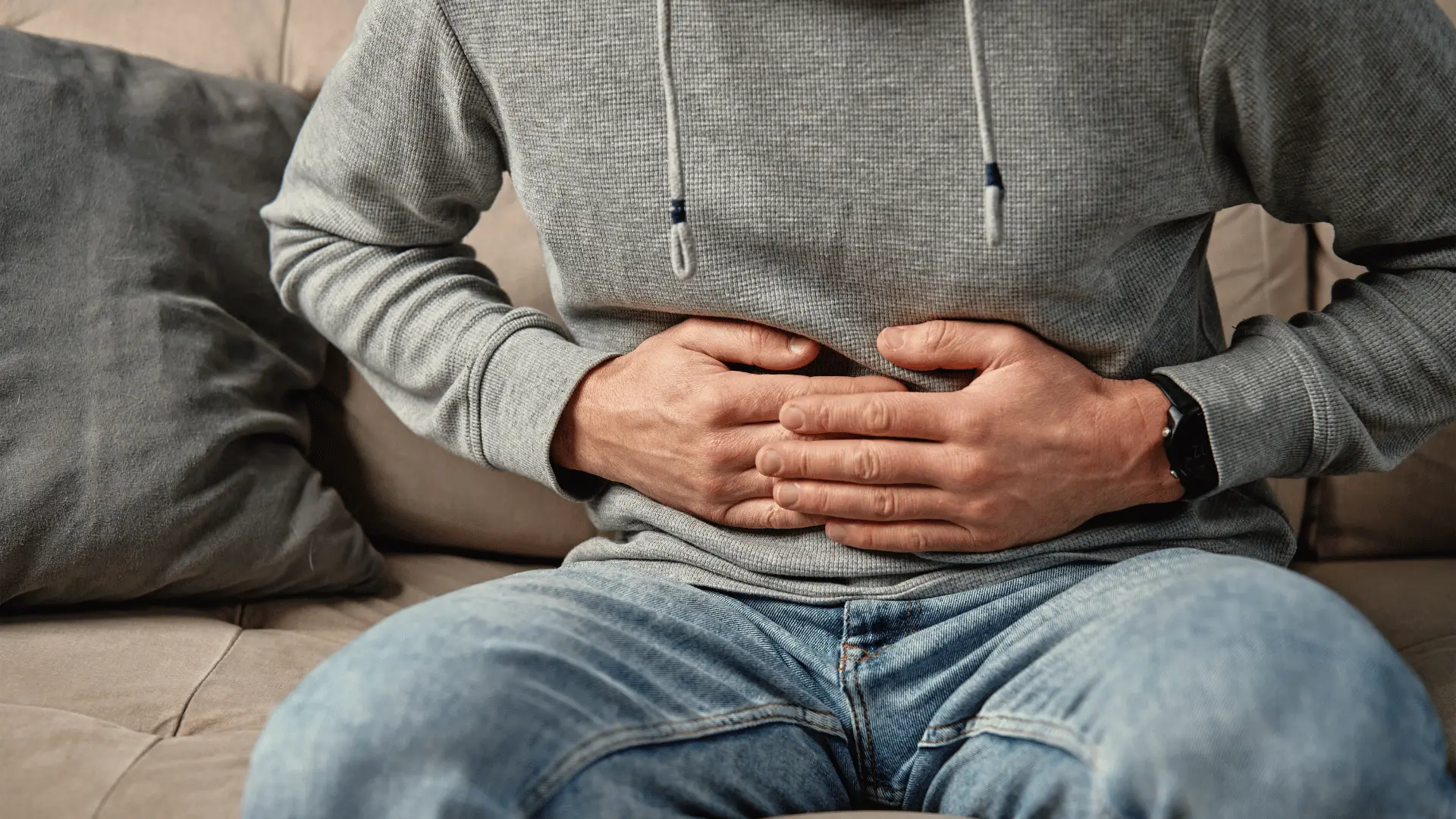Person experiencing stress-related digestive issues
